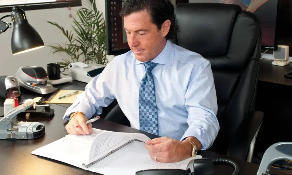 Picture of Ron Anfuso sitting at his desk working on a project for a client.